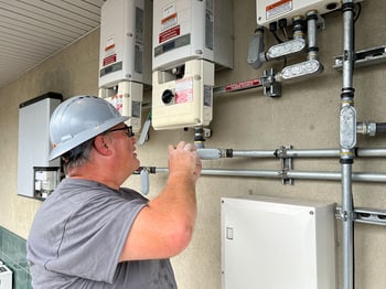 Paradise Energy Service Technician Completing Maintenance Services on A Solar Panel System